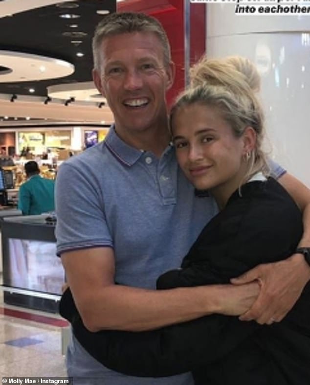 The policeman looked downcast on Thursday as he parked his car and headed inside the property with the pink and white flowers and a Tesco 's shopping bag (pictured with Molly in 2020)