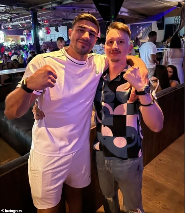 Onlookers have claimed the boxer 'didn't seem to care' who saw him brazenly kiss the blonde as he downed vodka and partied at a nightclub at 2am (pictured with a pal in Macedonia)