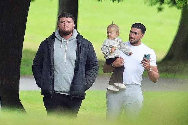 He carried the toddler in his arms as he treated her to an ice cream cone from a nearby ice cream van