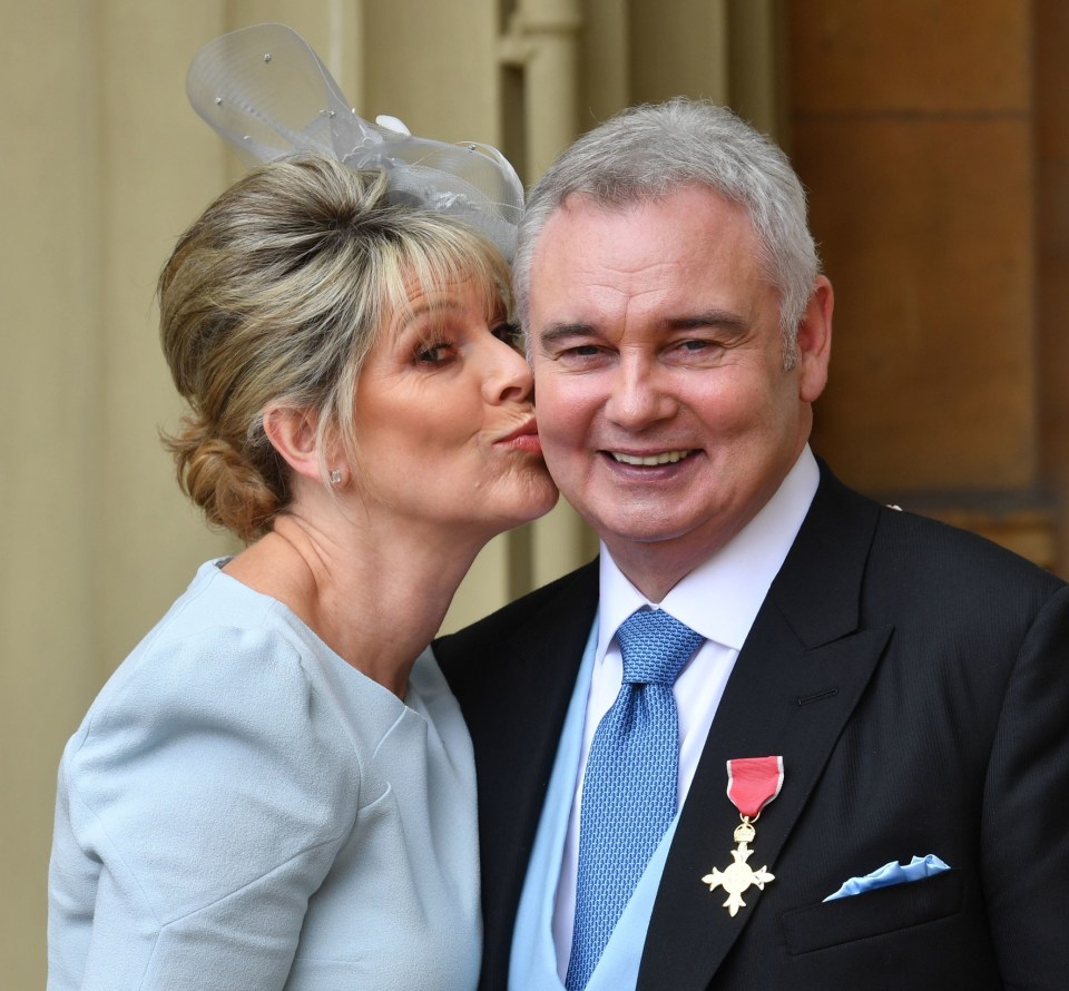 a woman kisses a man on the cheek in front of a building