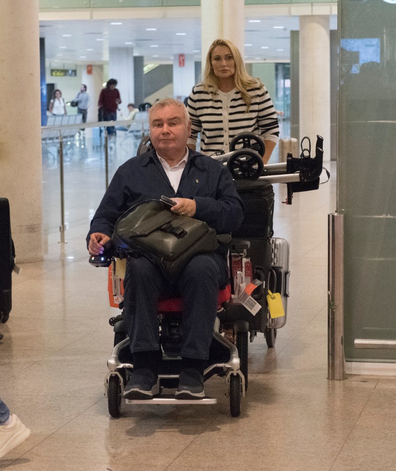 a man in a wheelchair is being pushed by a woman