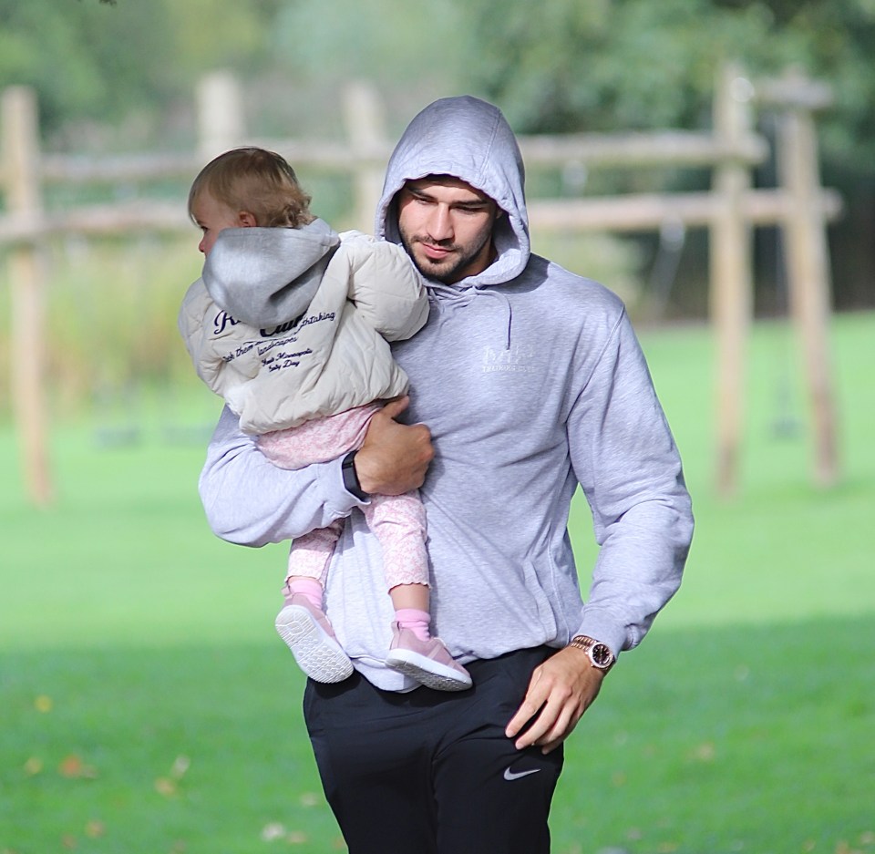 Tommy carried his daughter to their car